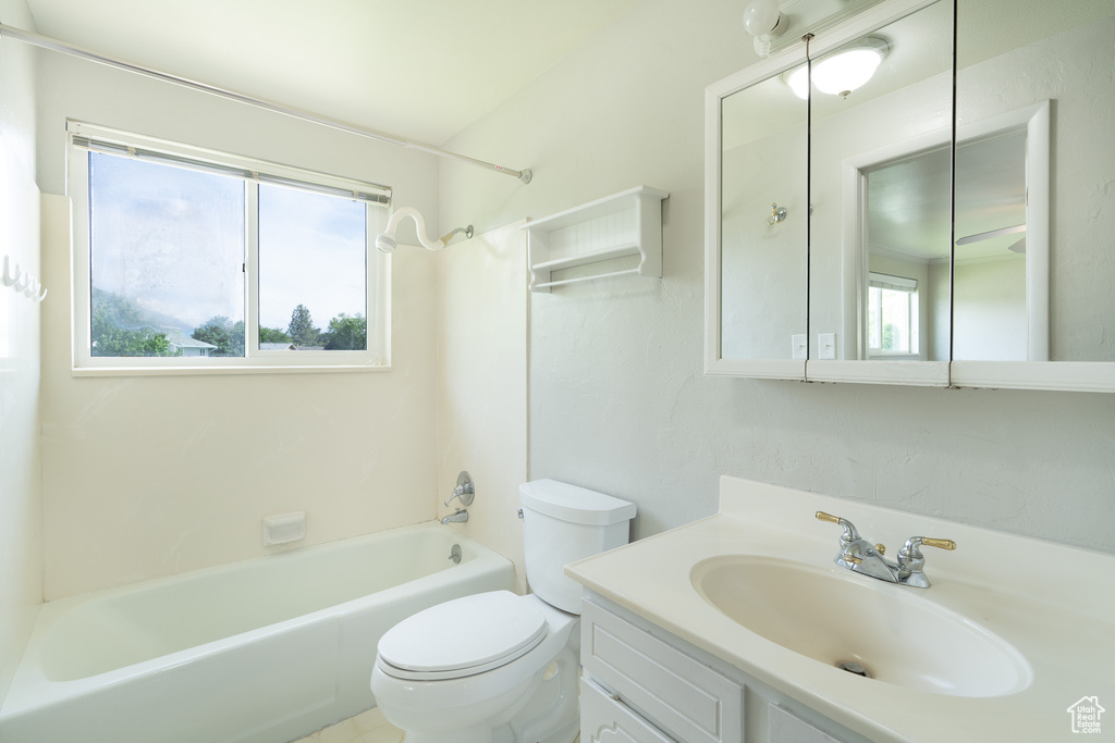 Bathroom with toilet, vanity, and shower / bath combination