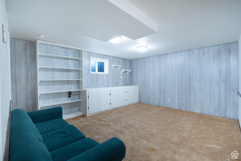 Unfurnished living room with carpet floors and wood walls