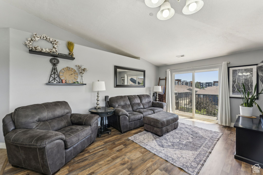 Living room featuring vaulted ceiling and dark wood finished floors