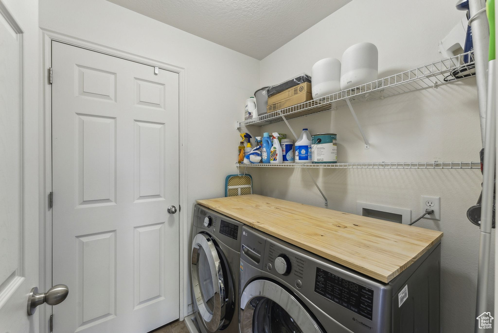 Washroom with washer and clothes dryer