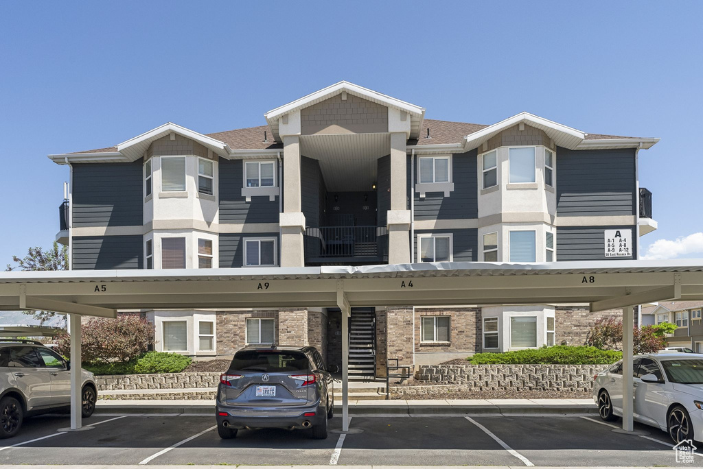 View of building exterior with covered parking