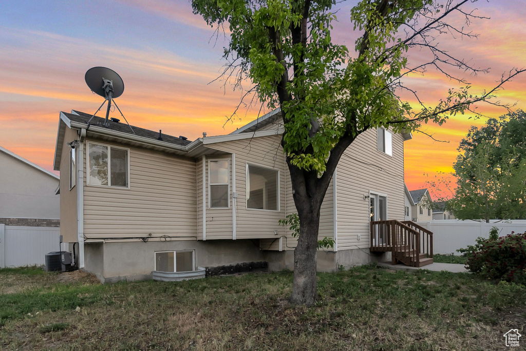 Rear view of house with central air condition unit