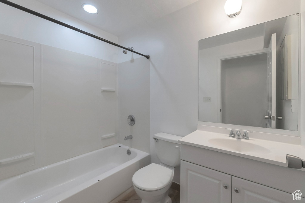 Full bath with toilet, vanity,  shower combination, and recessed lighting