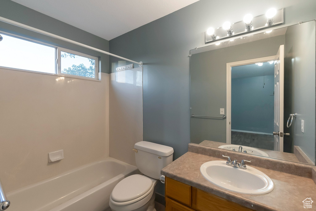 Full bath with toilet,  shower combination, and vanity