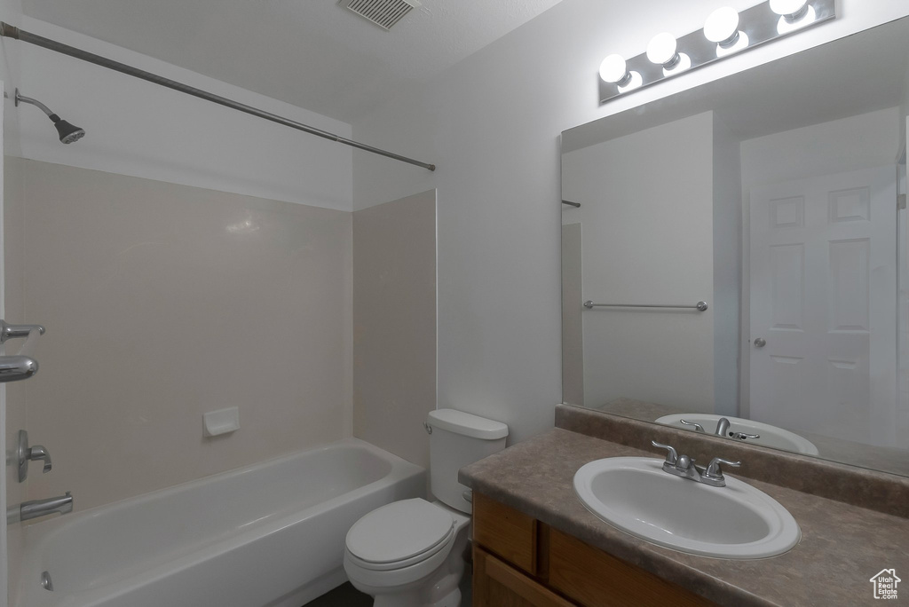 Full bathroom with tub / shower combination, vanity, and toilet
