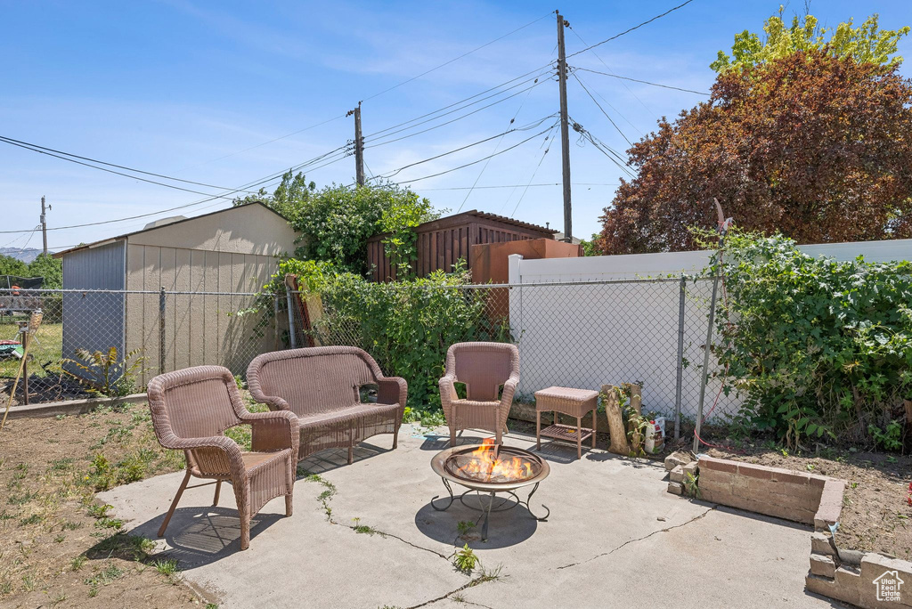 Fenced backyard featuring a patio area and an outdoor fire pit