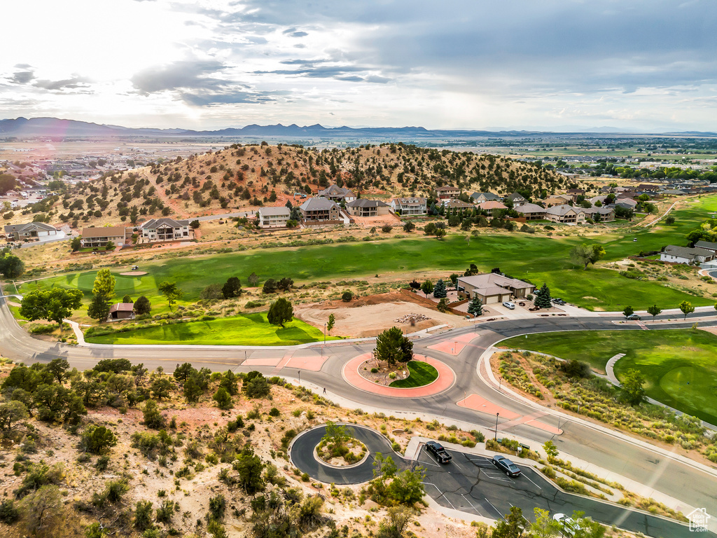 Aerial view of residential area with mountains and a golf club