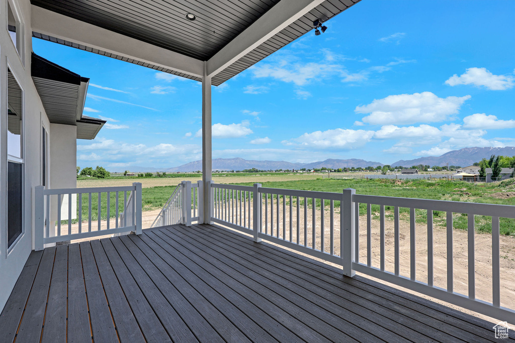 Wooden terrace featuring a mountain view and a rural view
