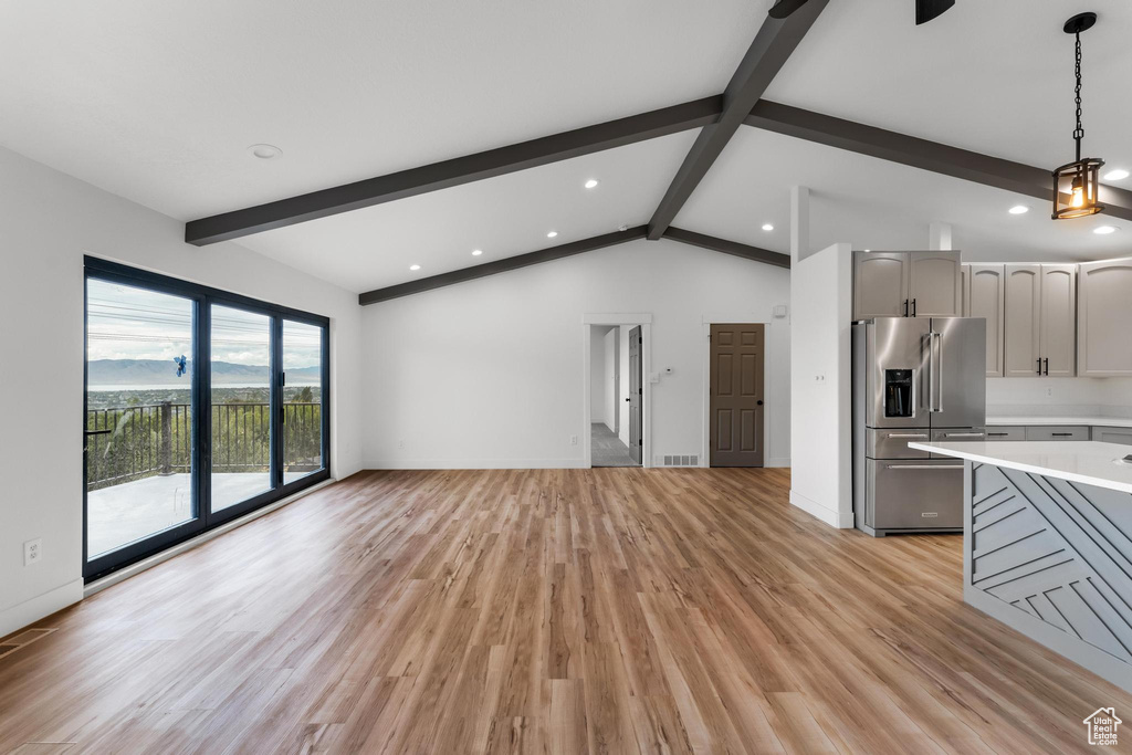 Unfurnished living room with recessed lighting, light wood-type flooring, and baseboards