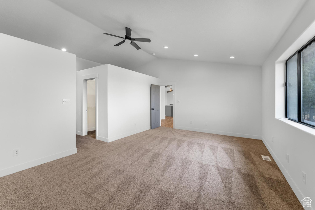 Unfurnished room with carpet flooring, ceiling fan, recessed lighting, vaulted ceiling, and baseboards