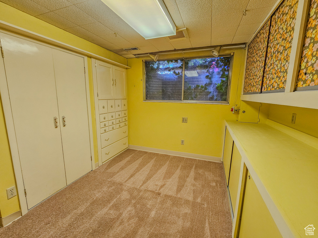 Unfurnished bedroom with light colored carpet