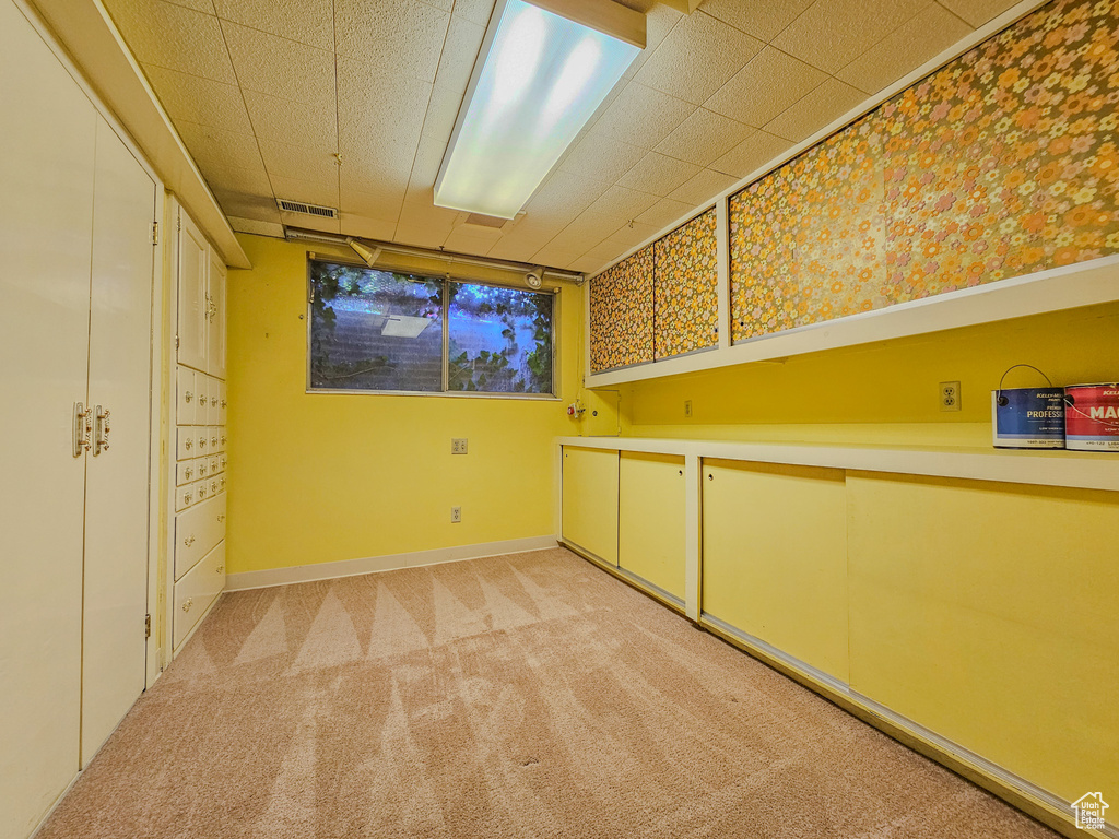 Spare room featuring light colored carpet and baseboards