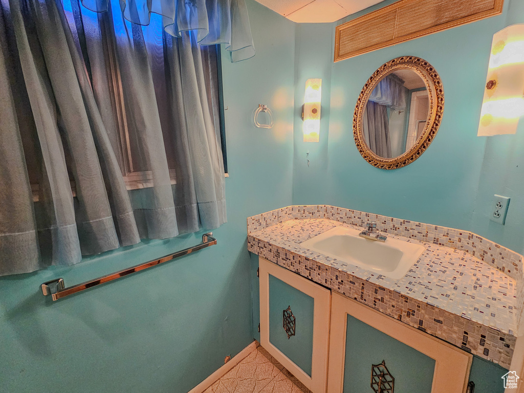 Bathroom featuring vanity and baseboards
