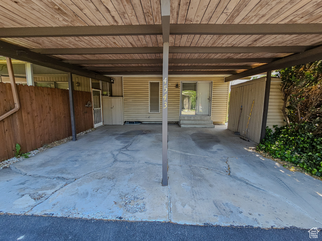 View of patio / terrace with a carport and entry steps