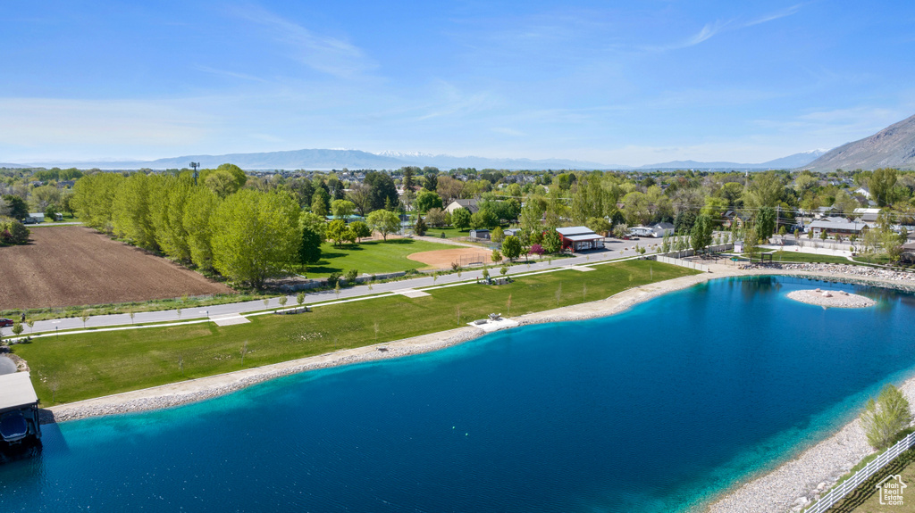 View of pool featuring a water and mountain view, an infinity pool, and a lawn