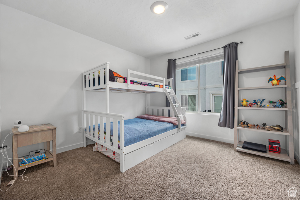 Carpeted bedroom with baseboards