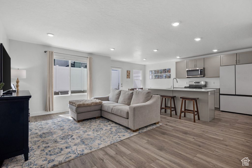 Living area with wood finished floors and recessed lighting