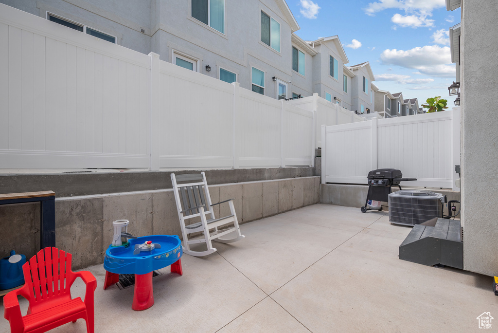 View of patio featuring a grill, central AC, and a residential view