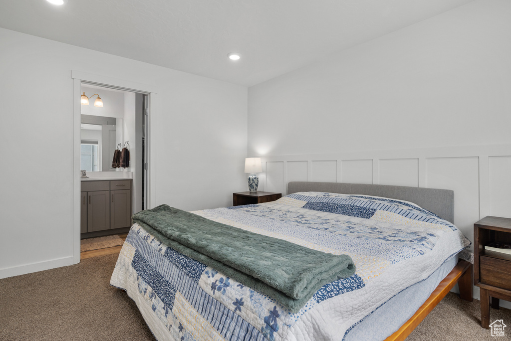 Bedroom featuring carpet flooring, a wainscoted wall, a decorative wall, and recessed lighting