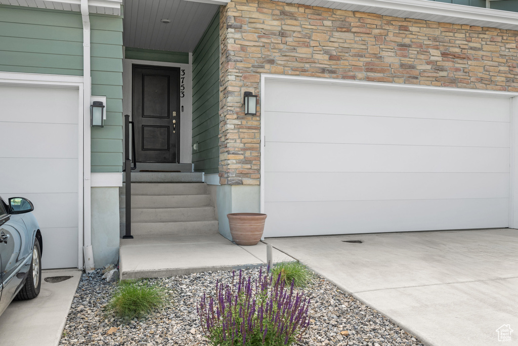 Entrance to property with stone siding