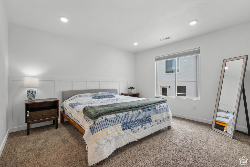Bedroom featuring carpet floors, recessed lighting, and wainscoting