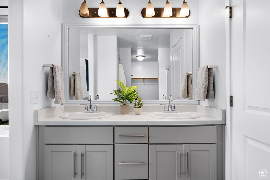 Bathroom with double vanity and a closet