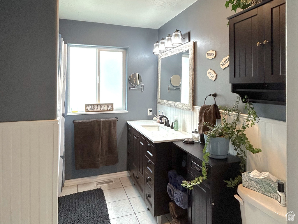 Bathroom with vanity, a textured ceiling, and toilet