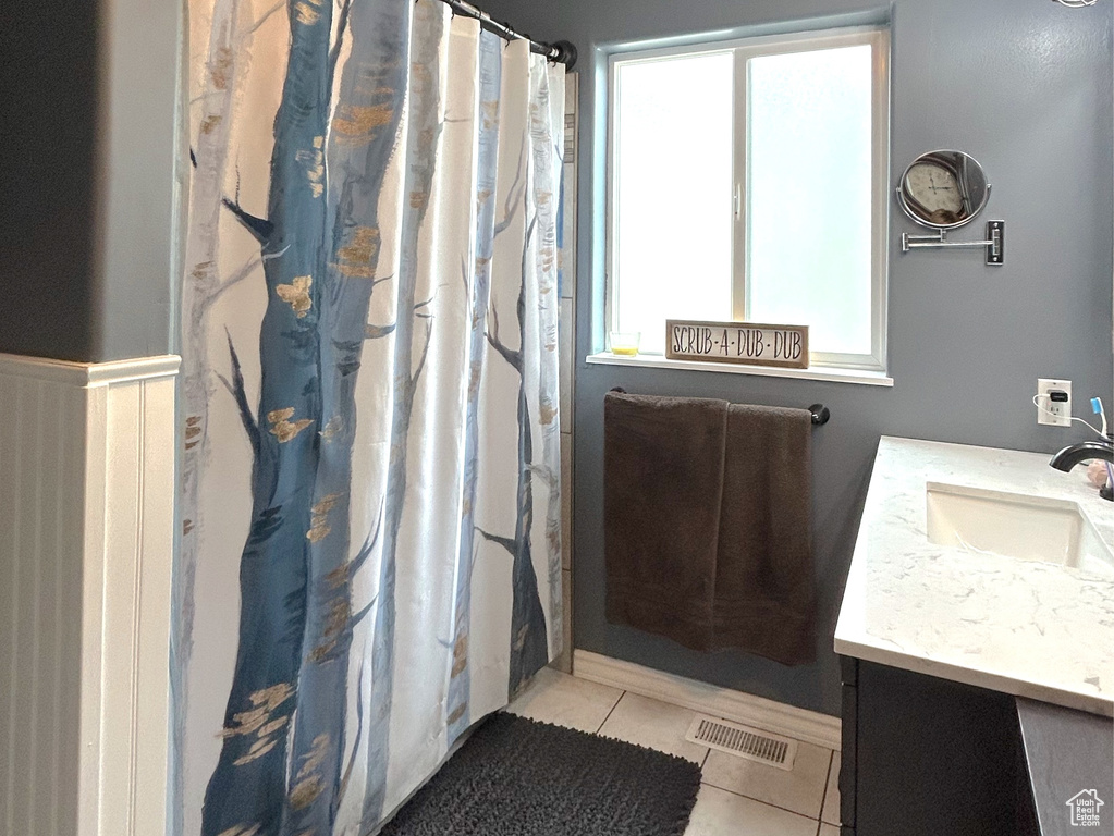 Full bath with vanity, tile patterned floors, and a shower with shower curtain