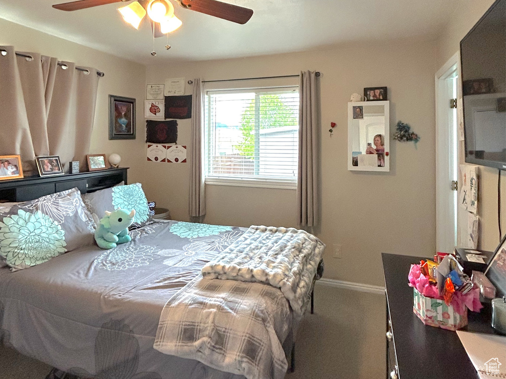 Bedroom featuring carpet floors, a ceiling fan, and baseboards