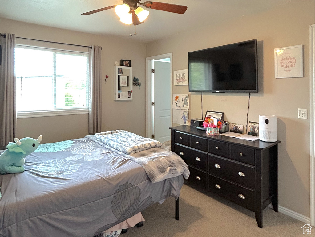 Bedroom with light carpet and ceiling fan
