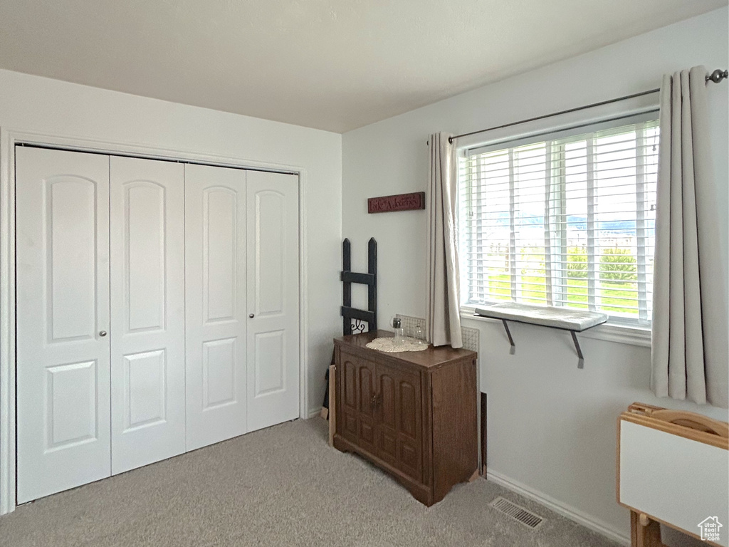 Carpeted bedroom with a textured ceiling, a closet, and baseboards