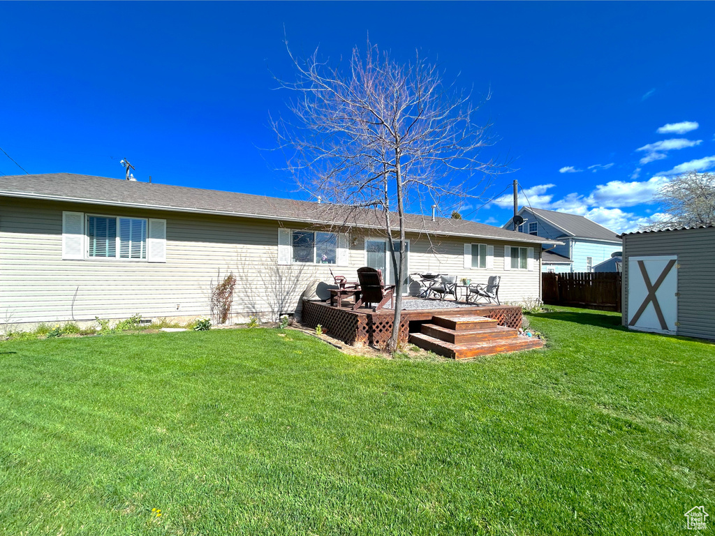 Back of house featuring a wooden deck