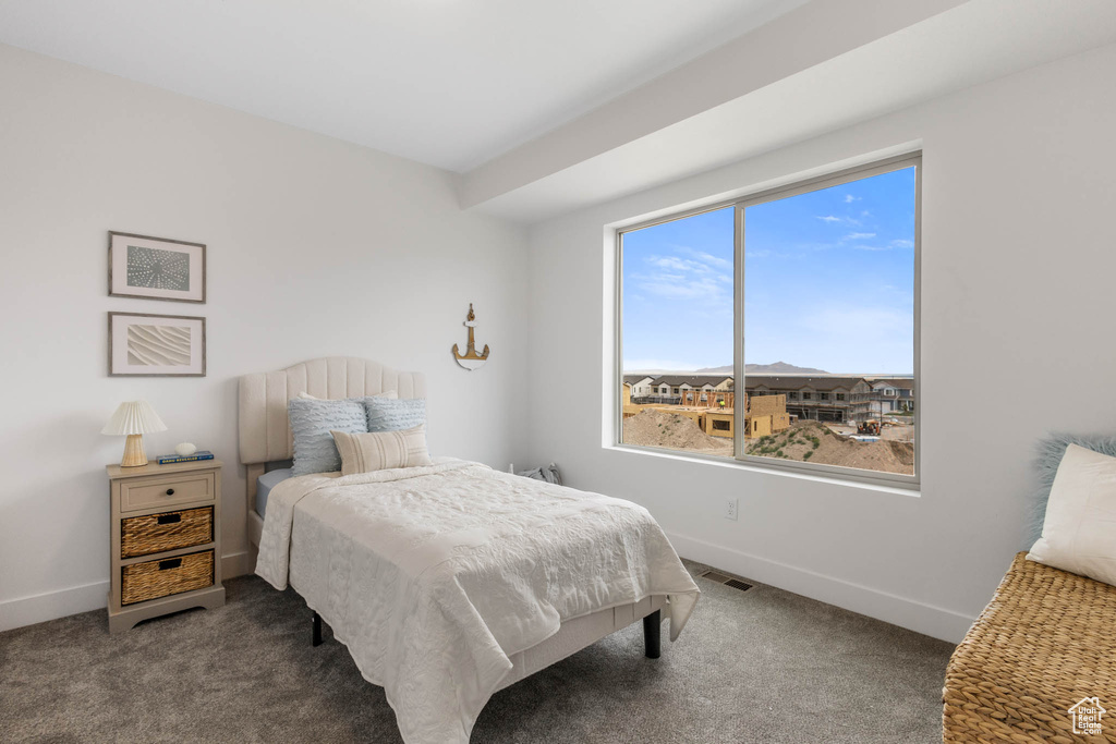 Bedroom featuring carpet floors and baseboards