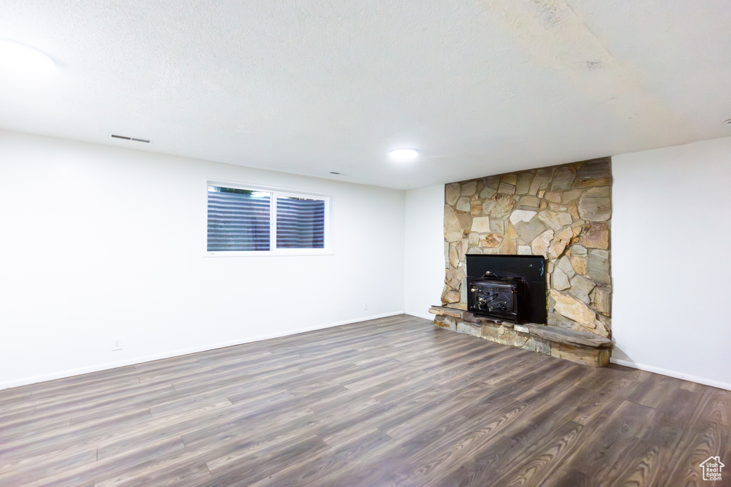 Unfurnished living room featuring wood finished floors and baseboards