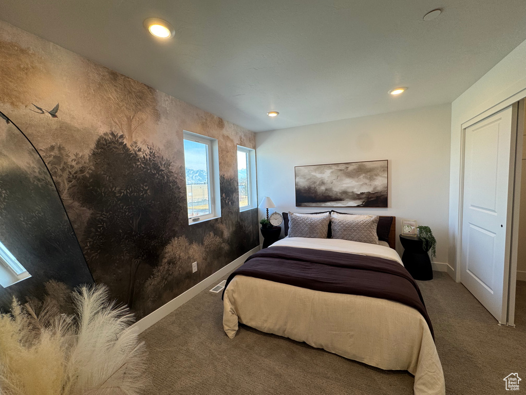 Carpeted bedroom with baseboards and recessed lighting