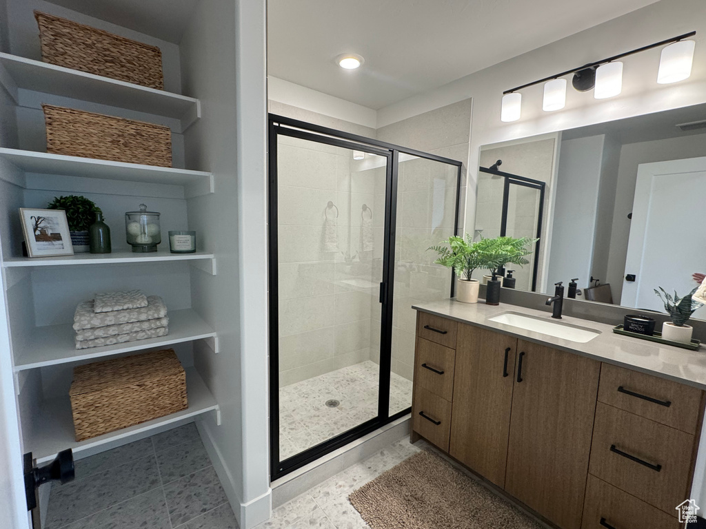 Bathroom featuring vanity, a shower stall, and recessed lighting