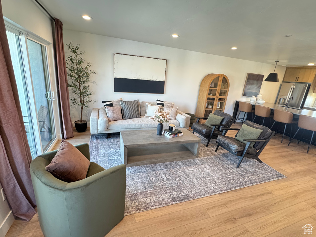 Living area featuring light wood-style floors and recessed lighting