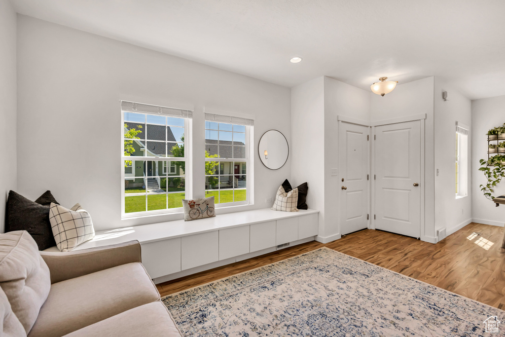 Living room featuring wood finished floors, recessed lighting, and baseboards