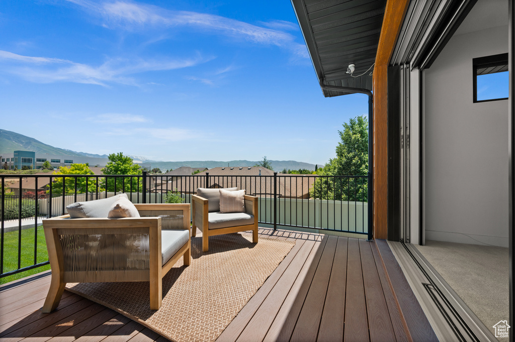 Wooden terrace featuring a mountain view and outdoor lounge area