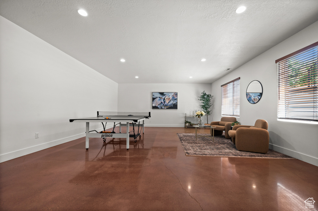 Dining space with concrete floors, baseboards, and recessed lighting