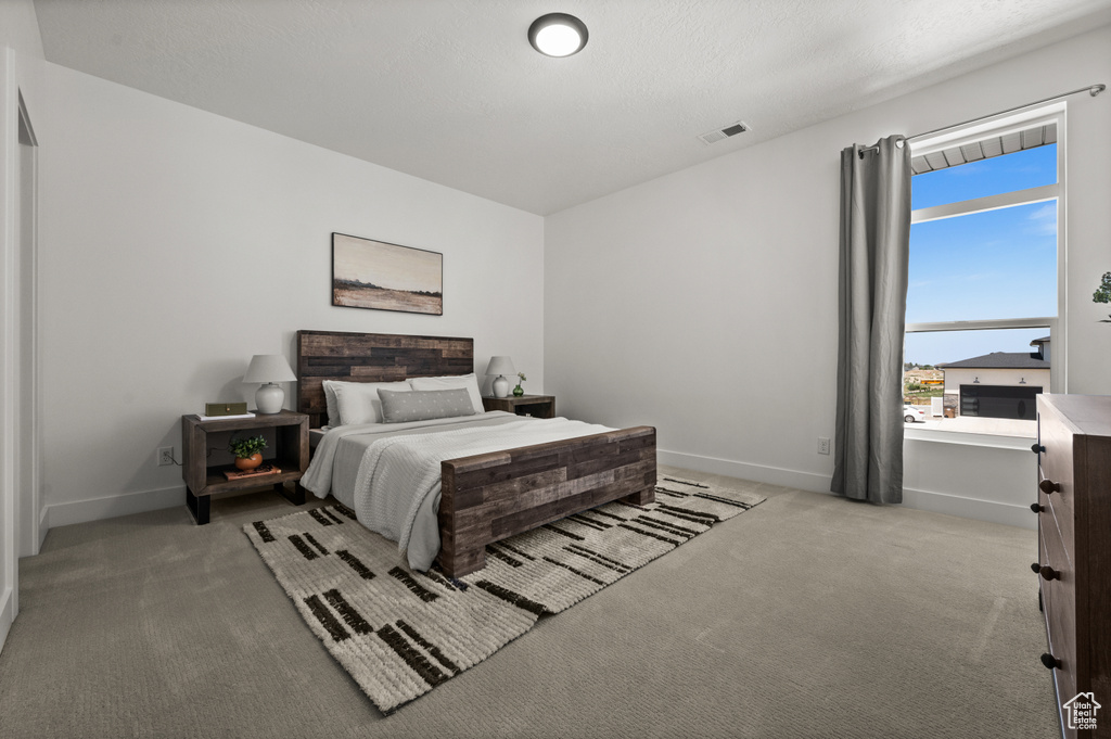 Carpeted bedroom with baseboards
