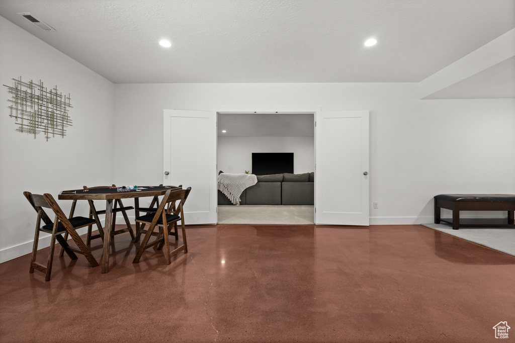 Dining area with finished concrete floors, recessed lighting, and baseboards