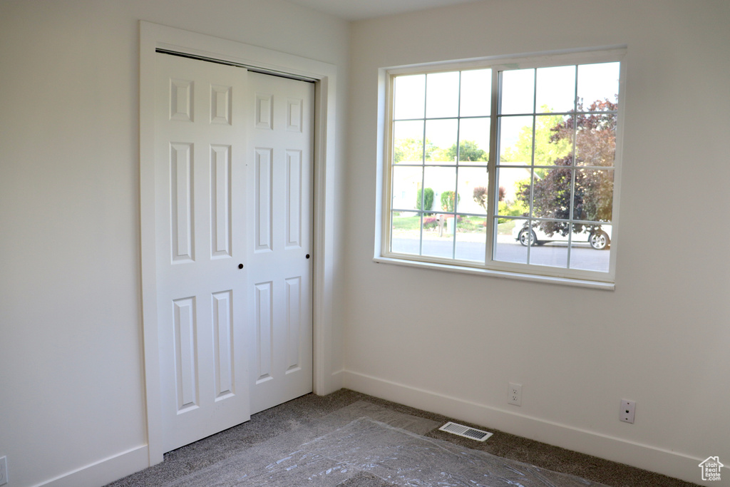Unfurnished bedroom featuring baseboards and a closet