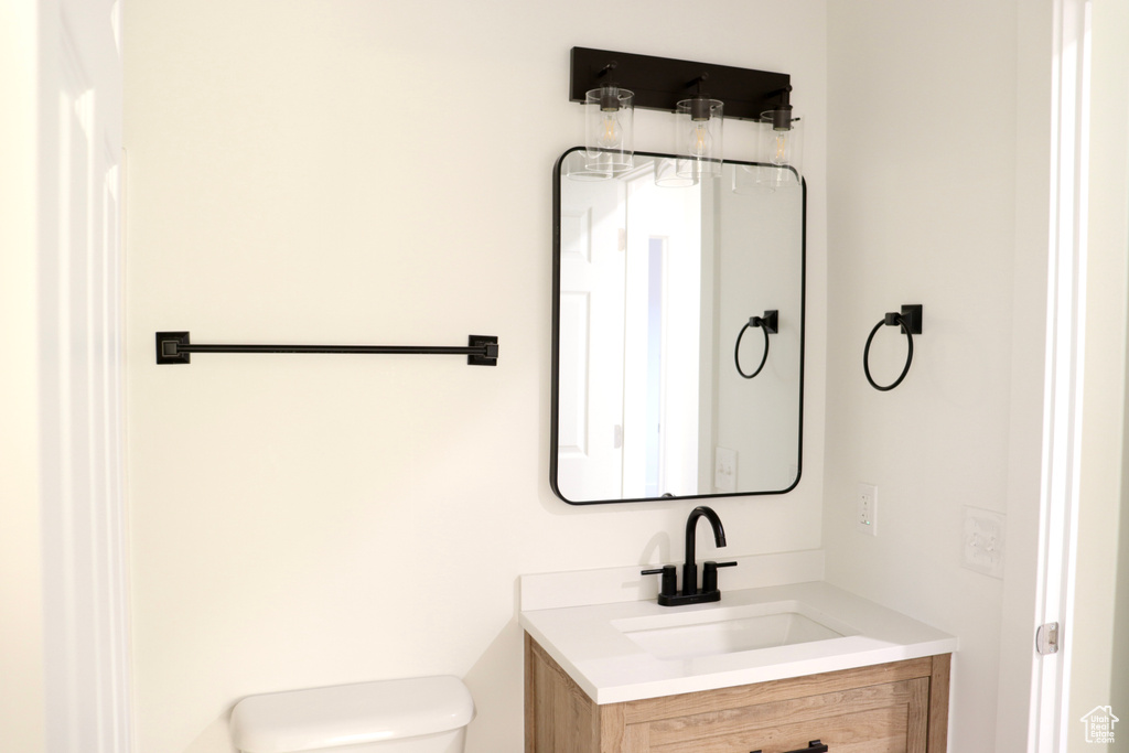 Half bath featuring vanity and toilet