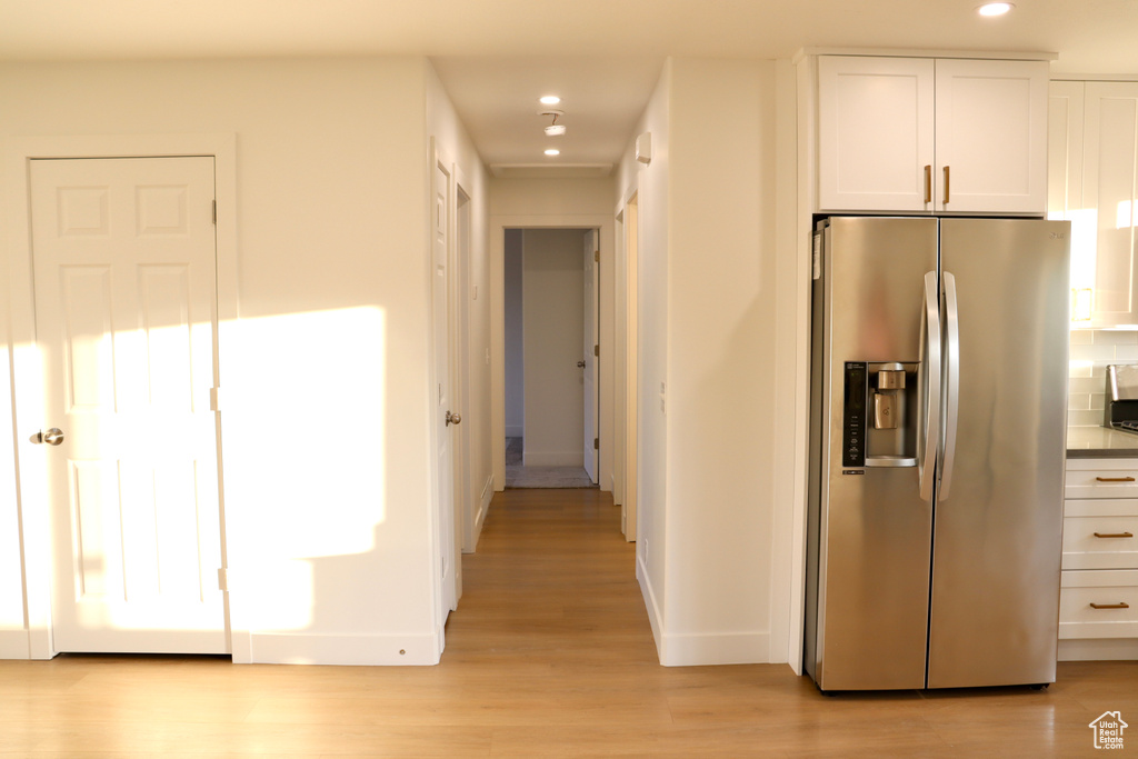Hallway featuring recessed lighting, baseboards, and light wood-style floors