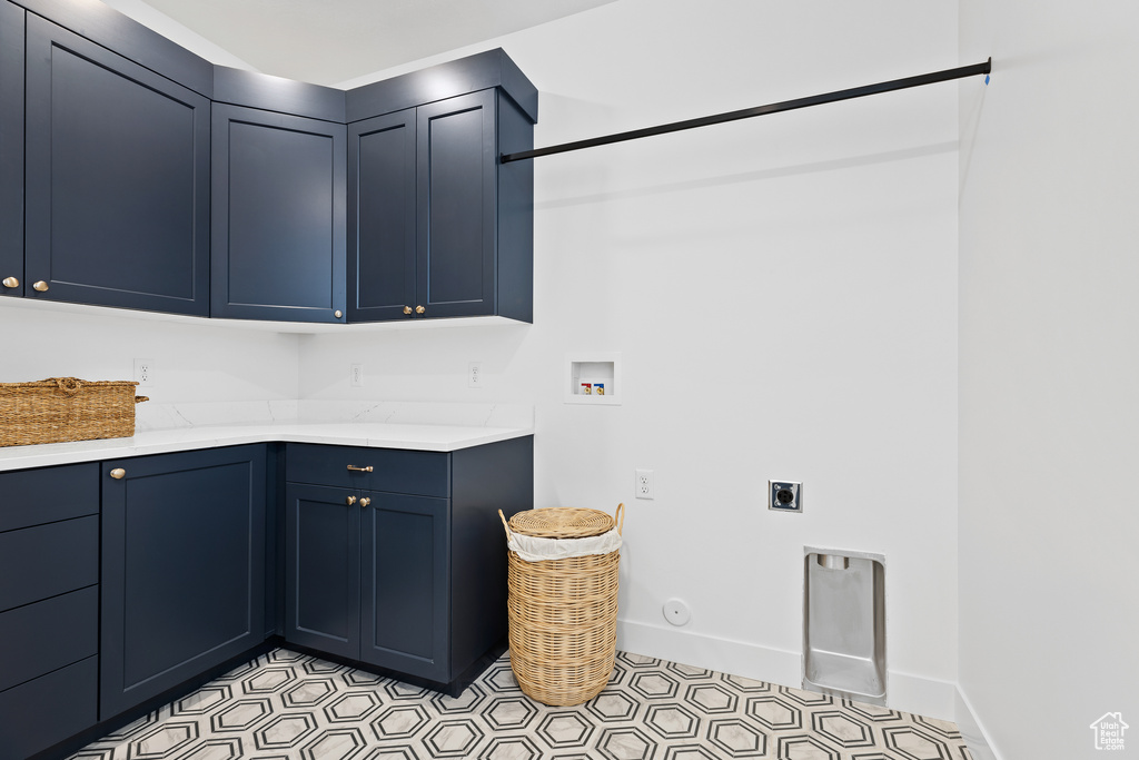 Laundry area featuring cabinet space, hookup for an electric dryer, washer hookup, and baseboards