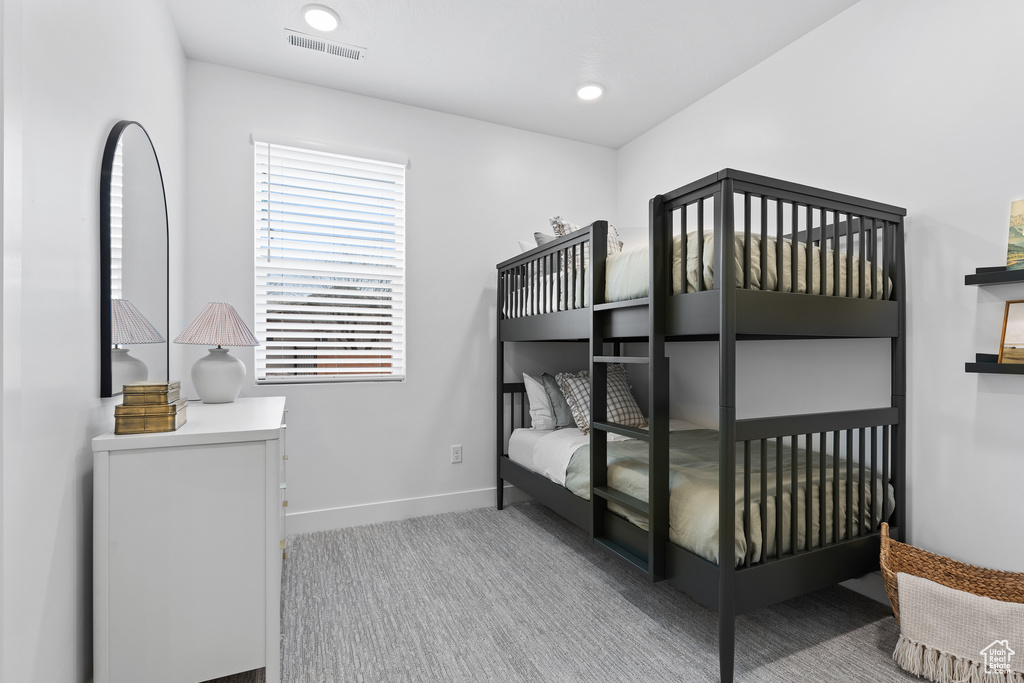 Carpeted bedroom featuring baseboards