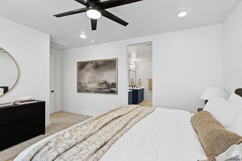 Bedroom with light colored carpet, recessed lighting, ceiling fan, baseboards, and connected bathroom