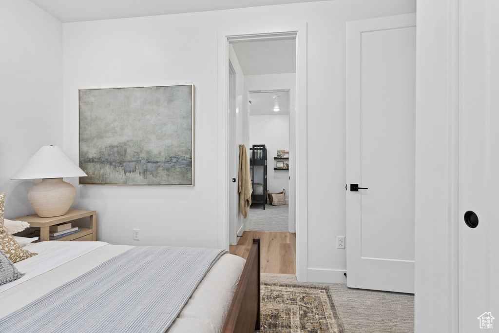 Carpeted bedroom featuring wood finished floors