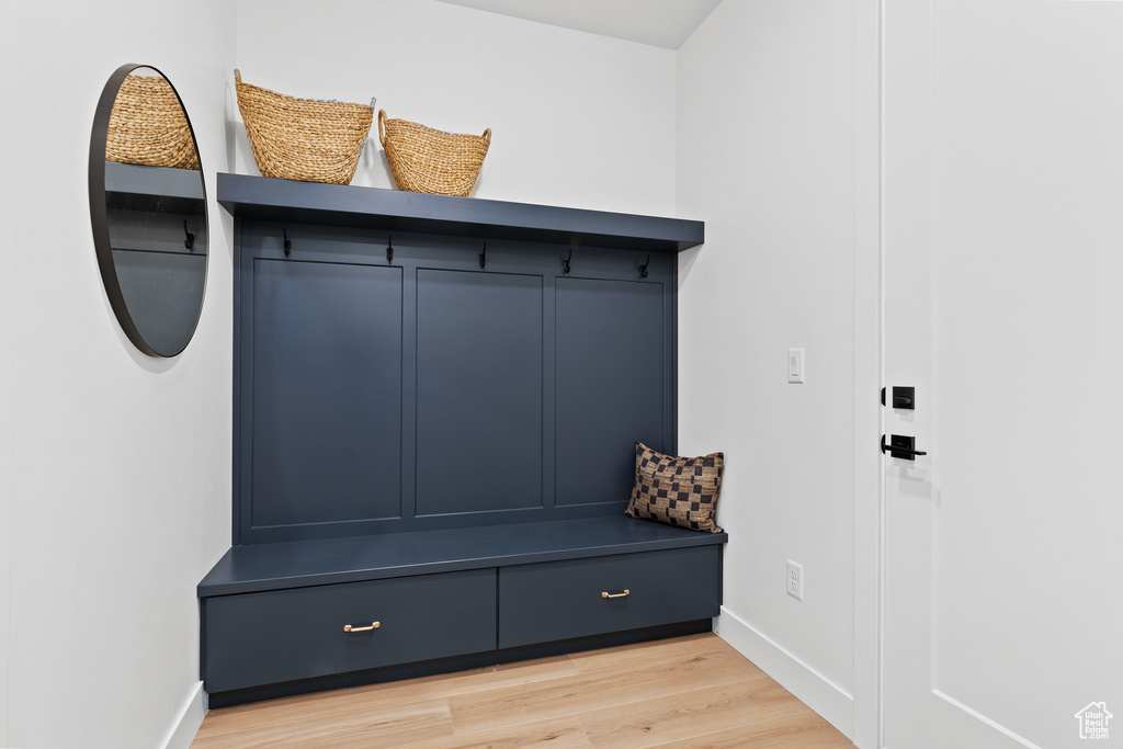 Mudroom featuring light wood-type flooring and baseboards
